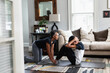 © Gerald Carter/Creative Flame - Black mom helps son do sit-ups at home, stay fit, health and wellness