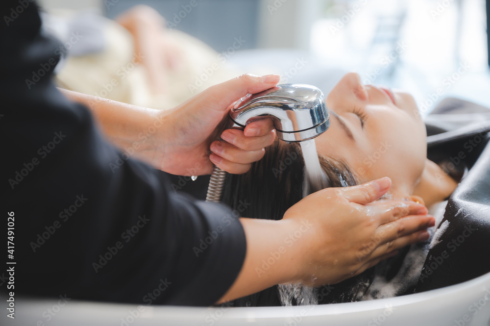 client woman clean washing a hair in salon, professional hairdresser washing haircut customer hair with water and shampoo treatment, coiffure beauty head hair care, fashion service - obrazy, fototapety, plakaty 