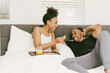 © Melissa Alexander/Creative Flame - Couple enjoys breakfast in bed at home