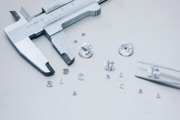 Macro close up of experienced goldsmith sorting high quality diamonds, selecting them to make precious jewels in workshop.Concept of jewelry,luxury,goldsmith, diamonds, brilliance.