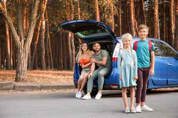 Canvas Print - Happy family near car outdoors