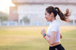© EduLife Photos - A young Asian woman athlete runner jogging on running track in city stadium in the sunny morning to keep fitness and healthy lifestyle. Young fitness woman runs on stadium track. Sport and recreation