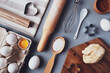 © LesDaMore - Flat layout composition, baking ingredients and kitchen utensils on a gray background. Culinary trendy background. The concept of making homemade desserts for the holiday