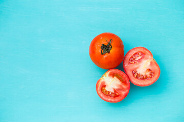 Fresh tomato on blue backgrund, organic vegetable, healthy life style, fresh furit, food ingredient