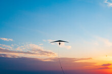 Hang Glider Wing On The Sunset.