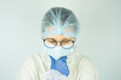 © Igorzvencom - portrait of a female doctor in an antibacterial suit, thinking or reflecting on the upcoming operation.