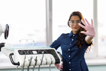 A young female dentist in uniform spends time in the dentist's office