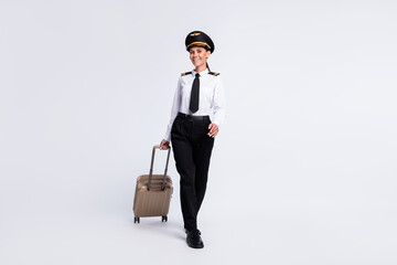 Sticker - Photo of lovely lady walk carry suitcase wear hat aviator uniform trousers shoes isolated white color background