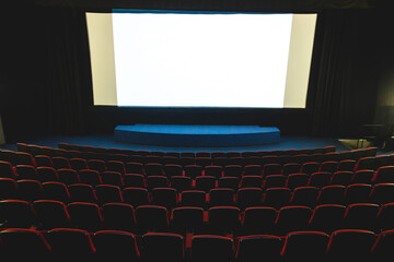 Sticker - Cinema interior. Chairs in a large empty cinema hall against a white projection screen