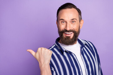 Wall Mural - Photo of promoter positive guy direct thumb empty space wear striped shirt isolated violet color background