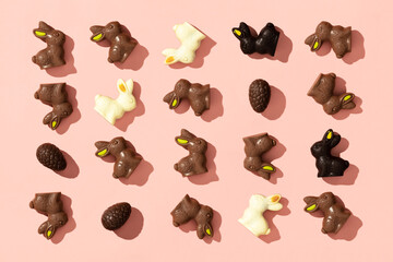 chocolate easter eggs and bunnies on pink background pattern