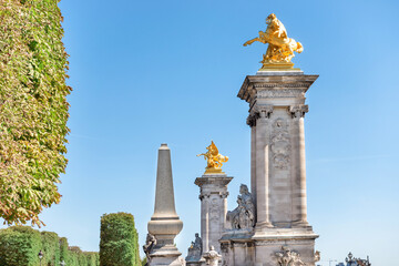 Wall Mural - Golden statues on Alexandre III bridge near Les Invalides in Paris, France