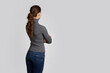 © spaxiax - Back view of a young woman is looking to copy space. Isolated