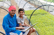 © PRASANNAPIX - Young indian farmer showing some information to his child on laptop at greenhouse