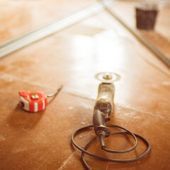 Grinding tool with abrasive cutting disc on the dirty brown floor