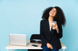© luismolinero - African american business woman working in her workplace looking up while smiling