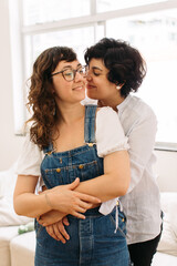 Wall Mural - Affectionate lesbian couple indoors