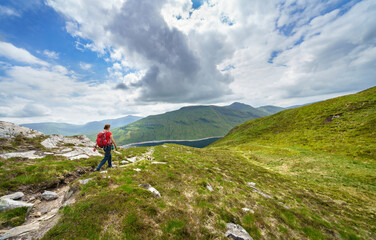 Poster - A female hiker descending the summit Meall a Phuill towards Loch an Daimh in the Scottish Highland mountains, UK landscapes.