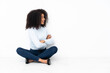 Young african american woman sitting on the floor in lateral position