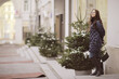 © kichigin19 - adult model girl in a coat on a winter walk in the city / Christmas vacation city tour