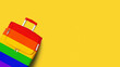 © Vera NewSib - Suitcase LGBTQ community flag colors, rainbow baggage, colorful luggage, trolley bag yellow background, LGBT pride people travel banner, gay, lesbian etc summer holidays, vacation, tourism, copy space