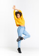 © luismolinero - Young African American woman dancing over isolated white background