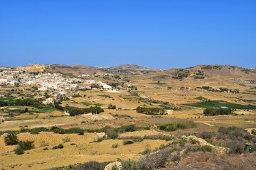 Sticker - Terraced fields and hills in the countryside of Gozo in the Mediterranean in summer. A sunny destination with sea and blue sky in the Maltese Islands.