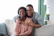 © Prostock-studio - Portrait of happy black couple hugging at home
