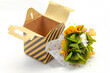 small and delicate floral arrangement of preserved flowers in cardboard box