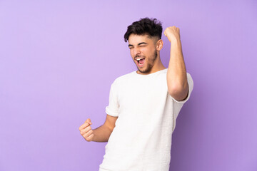 Arabian handsome man over isolated background celebrating a victory