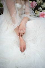 Wall Mural - the bride sits with her hands folded on the dress