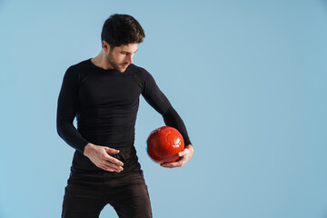 Wall Mural - Handsome athletic sportsman working out with medicine ball