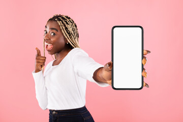 Black woman showing blank empty smartphone screen for mockup