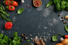 Food Cooking Background. Fresh Rosemary, Cilantro, Basil, Cherry Tomatoes, Peppers And Olive Oil, Spices Herbs And Vegetables At Black Slate Table. Food Ingredients Top View.