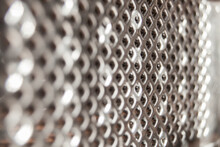 Closeup On Metal Grater With Holes And Light