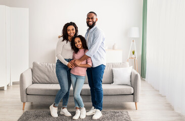 Wall Mural - Portrait of a happy black family smiling at home