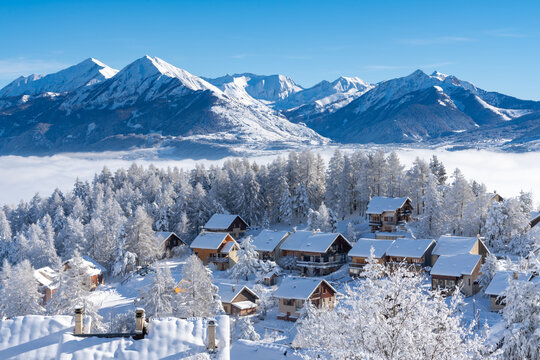 fresh snow covers roofs and trees of laye winter ski resort in champsaur, french alps. hautes-alpes,