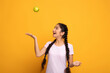 Portrait of a cheerful young woman juggling green apple