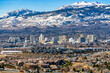 City of Reno Nevada cityscape showing the downtown skyline with Hotels, Casinos and the surrounding residential area with snow capped mountains background.