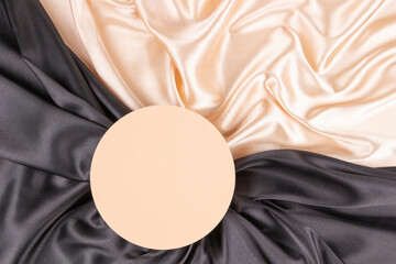Wall Mural - Circle platform podium on elegant black and champagne color background with drapery and wavy folds of silk satin cloth