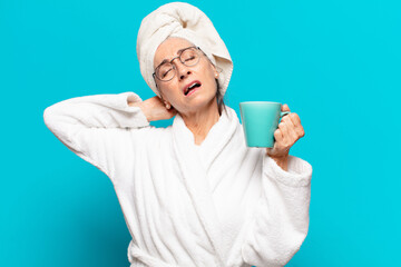 Wall Mural - senior pretty woman   wearing bathrobe and having a coffee