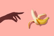 © Northern life - Symbol of the penis in the form of a ripe banana with blurred censored squares and female hand on a pink background, place for text. Sex concept of man's potency and erection.