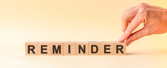 woman made word REMINDER with wood blocks