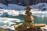 Fototapeta  - Cairn in front of a mountain lake with icebergs, Montana