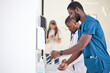 © Roman - Black Doctor Man washing hands properly with soap to be protected for Coronavirus 2019-nCoV during work in hospital. Medical Cleanup