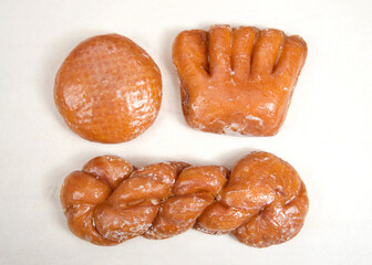 Wall Mural - Flat lay top view  of donuts arranged on parchment paper clustered together. Bear Claw, Cinnamon Twist, jelly filled on parchment paper