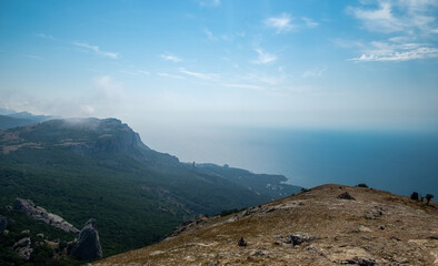 Mediterranean landscape. Forested rocks of the Black Sea coast of the southern coast of the Crimean Peninsula on a clear sunny day.