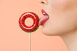 © Pixel-Shot - Beautiful young woman with inflatable ring on stick against color background