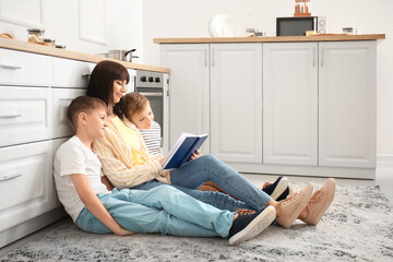 Poster - Happy mother and little boys reading book at home