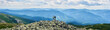 © anatoliy_gleb - Panorama of Carpathian mountains with green forests, rear view pair is holding hands and enjoying powerful view. Man and woman is standing on top of cliff under the sky with cumulus clouds